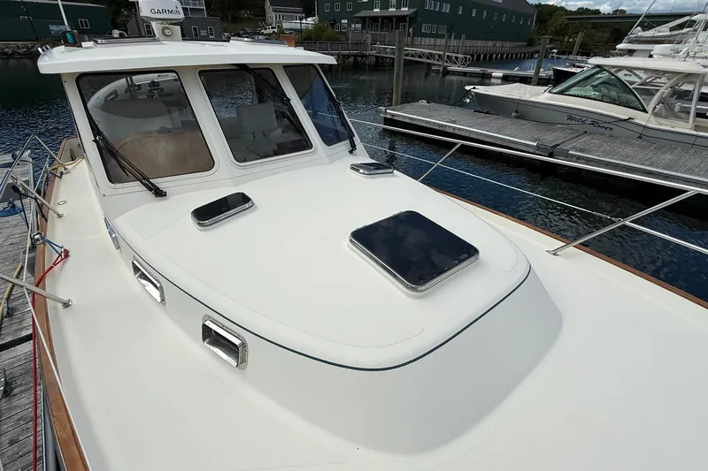 Tova Yacht Photos Pics 2007 Legacy Yachts 32 Sedan docked, showcasing sleek design and spacious deck.