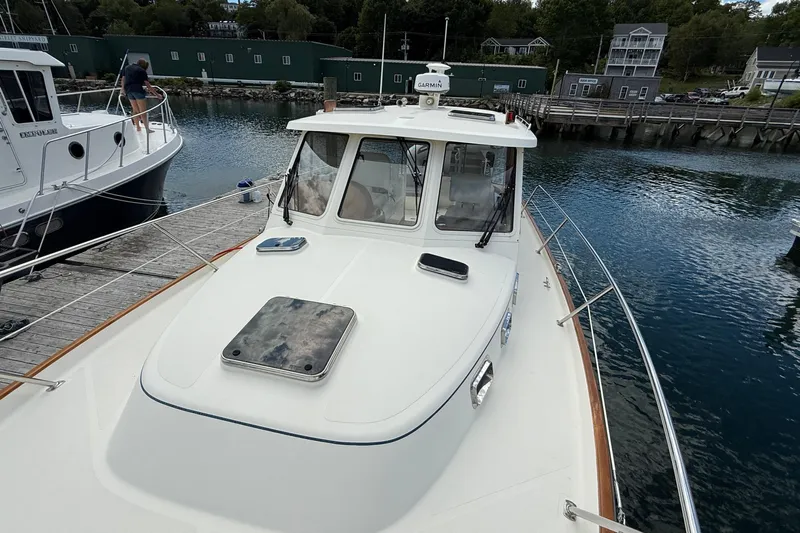 Tova Yacht Photos Pics 2007 Legacy Yachts 32 Sedan docked at a marina, showcasing its sleek design.