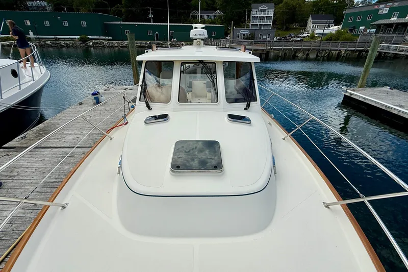 Tova Yacht Photos Pics 2007 Legacy Yachts 32 Sedan docked at a marina, showcasing its sleek design.