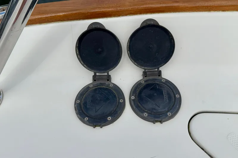 Tova Yacht Photos Pics Deck fittings on 2007 Legacy Yachts 32 Sedan, featuring two open circular hatches.