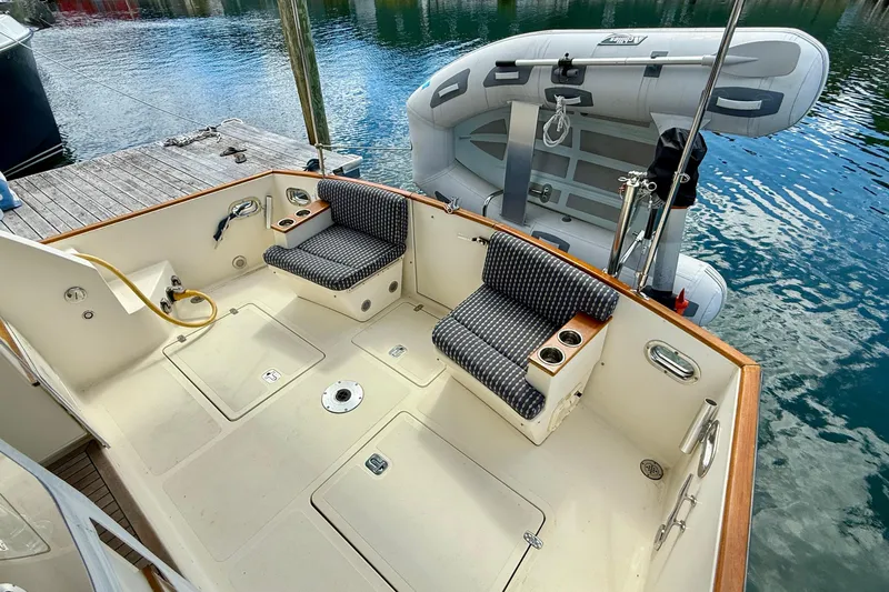 Tova Yacht Photos Pics 2007 Legacy Yachts 32 Sedan cockpit with seating and docked inflatable boat.