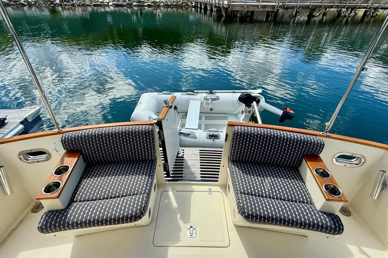 Tova Yacht Photos Pics 2007 Legacy Yachts 32 Sedan interior with cushioned seating and water view.