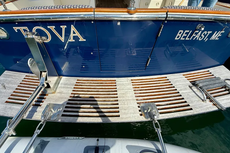 Tova Yacht Photos Pics 2007 Legacy Yachts 32 Sedan with wooden swim platform, named "TOVA," docked in Belfast, ME.