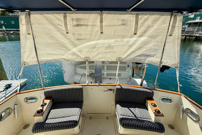 Tova Yacht Photos Pics 2007 Legacy Yachts 32 Sedan cockpit with seating, cup holders, and water view.