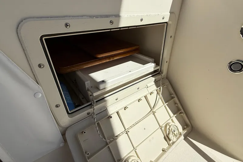 Tova Yacht Photos Pics Storage compartment on a 2007 Legacy Yachts 32 Sedan, featuring a secure latch and interior shelving.