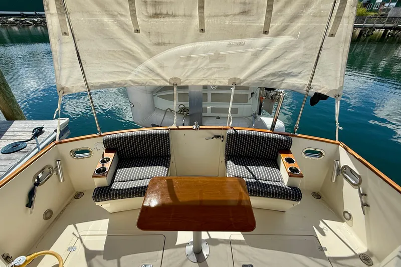 Tova Yacht Photos Pics 2007 Legacy Yachts 32 Sedan cockpit with seating, table, and waterfront view.