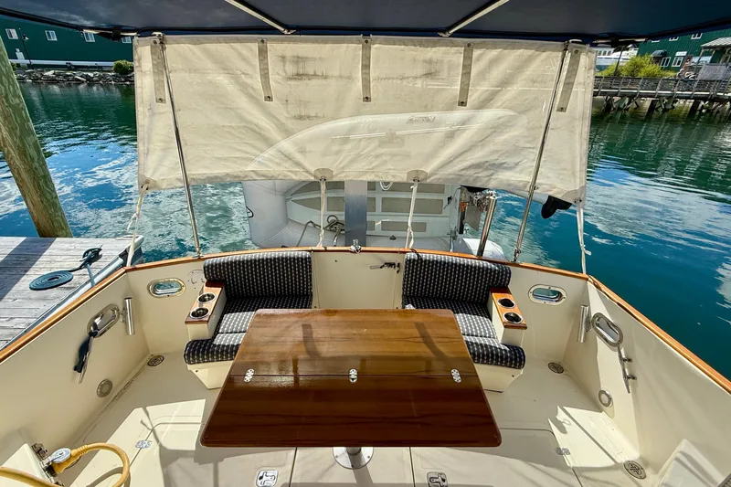 Tova Yacht Photos Pics 2007 Legacy Yachts 32 Sedan cockpit with seating, table, and waterfront view.