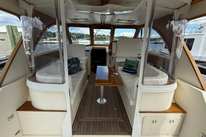 Tova Yacht Photos Pics Interior of 2007 Legacy Yachts 32 Sedan with seating and wooden accents.