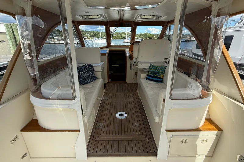 Tova Yacht Photos Pics 2007 Legacy Yachts 32 Sedan interior with wood flooring and cushioned seating.