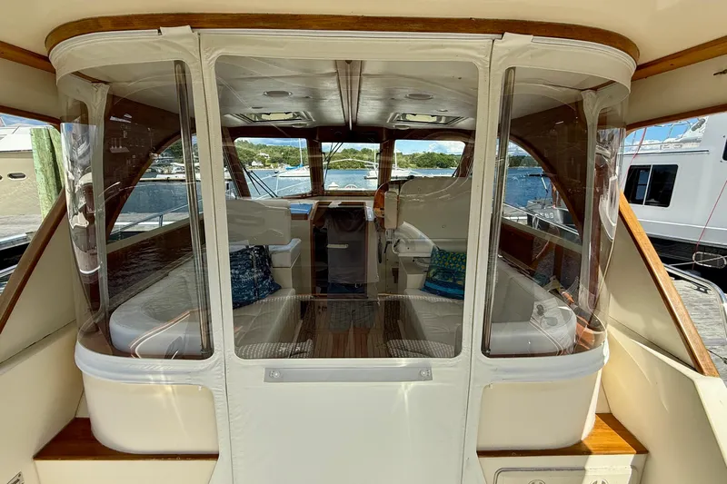 Tova Yacht Photos Pics 2007 Legacy Yachts 32 Sedan interior with seating, wood accents, and marina view.