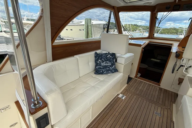Tova Yacht Photos Pics Interior of 2007 Legacy Yachts 32 Sedan with white seating and nautical decor.