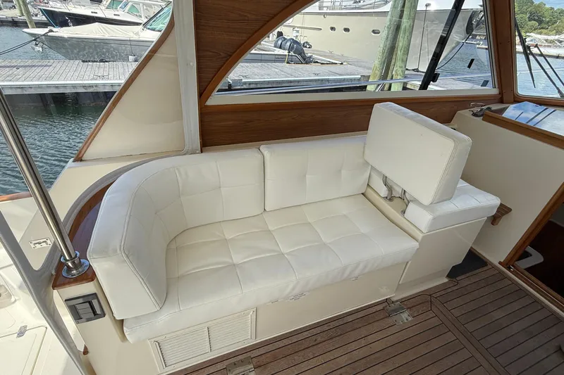 Tova Yacht Photos Pics Luxurious white seating on 2007 Legacy Yachts 32 Sedan, docked at marina.