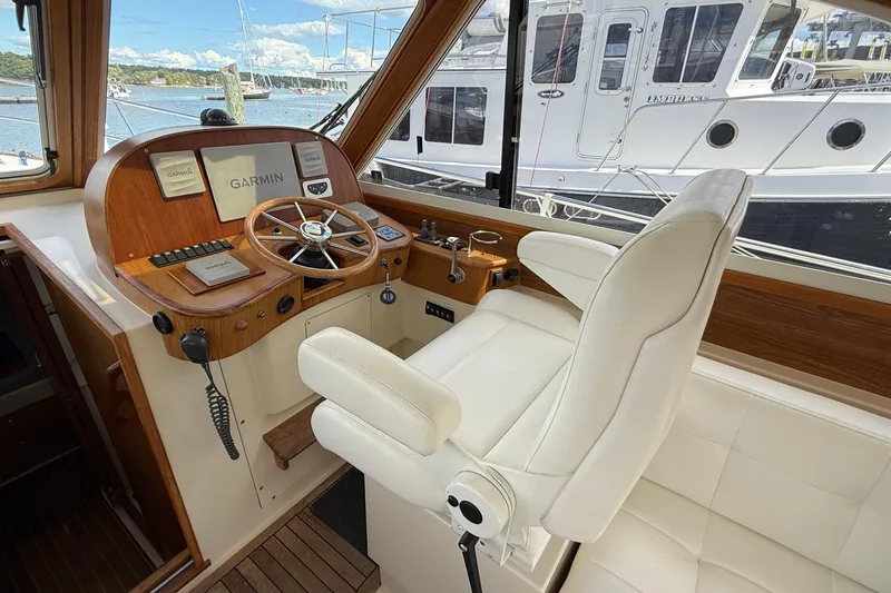 Tova Yacht Photos Pics Helm of 2007 Legacy Yachts 32 Sedan with Garmin navigation, overlooking marina.