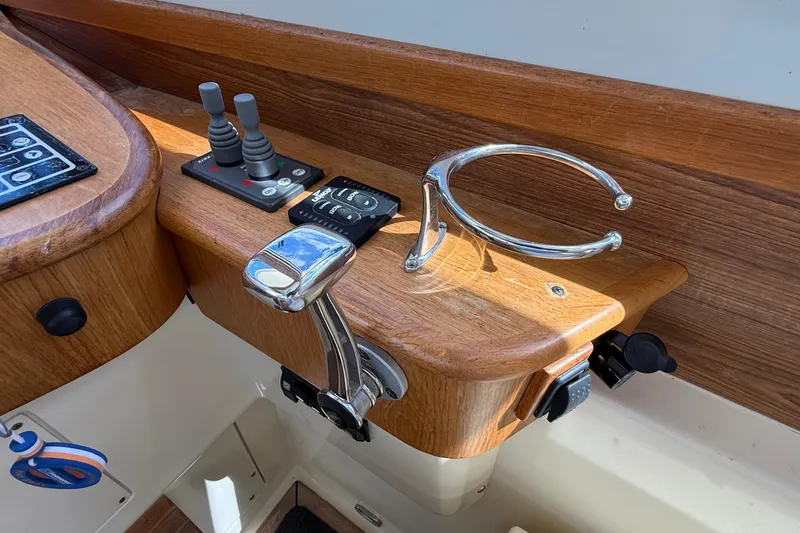 Tova Yacht Photos Pics Control panel of 2007 Legacy Yachts 32 Sedan with wooden finish and chrome details.