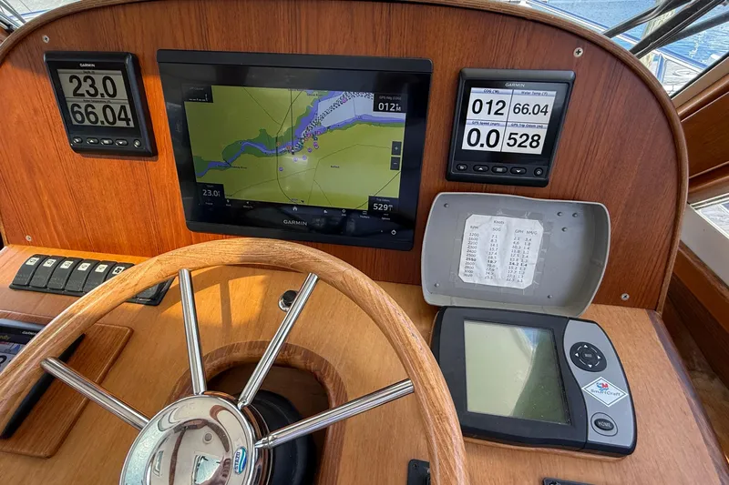 Tova Yacht Photos Pics Legacy Yachts 32 Sedan 2007 helm with Garmin navigation and steering wheel.