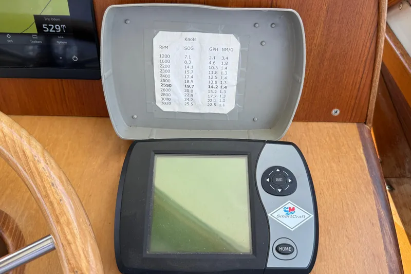 Tova Yacht Photos Pics SmartCraft display on 2007 Legacy Yachts 32 Sedan dashboard with performance chart.