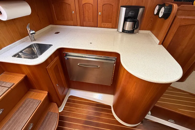 Tova Yacht Photos Pics 2007 Legacy Yachts 32 Sedan galley with sink, countertop, and coffee maker.