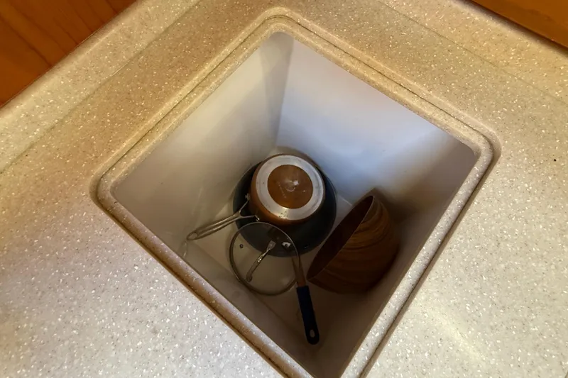 Tova Yacht Photos Pics Storage compartment with kitchenware in 2007 Legacy Yachts 32 Sedan.