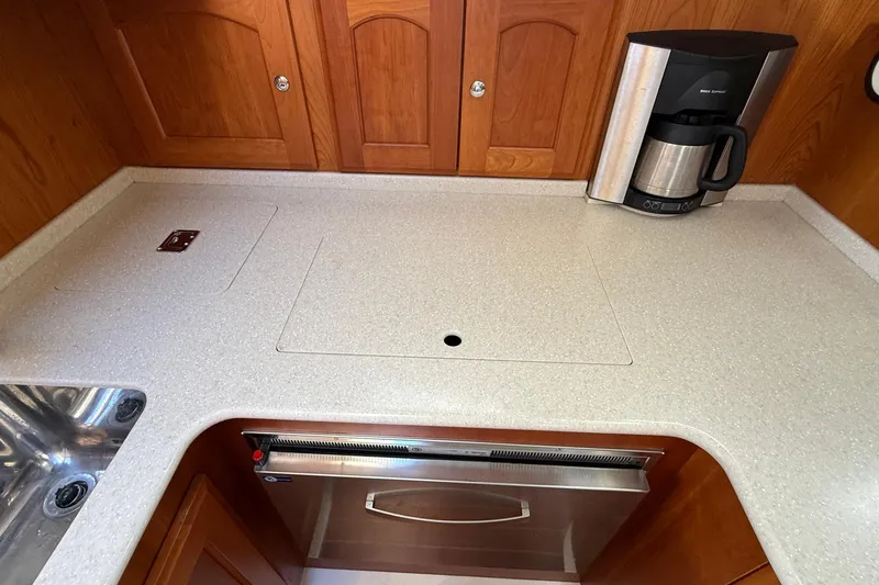 Tova Yacht Photos Pics 2007 Legacy Yachts 32 Sedan galley with countertop, sink, and coffee maker.