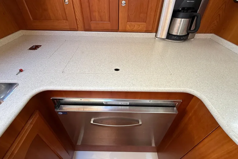 Tova Yacht Photos Pics 2007 Legacy Yachts 32 Sedan galley with countertop, dishwasher, and coffee maker.