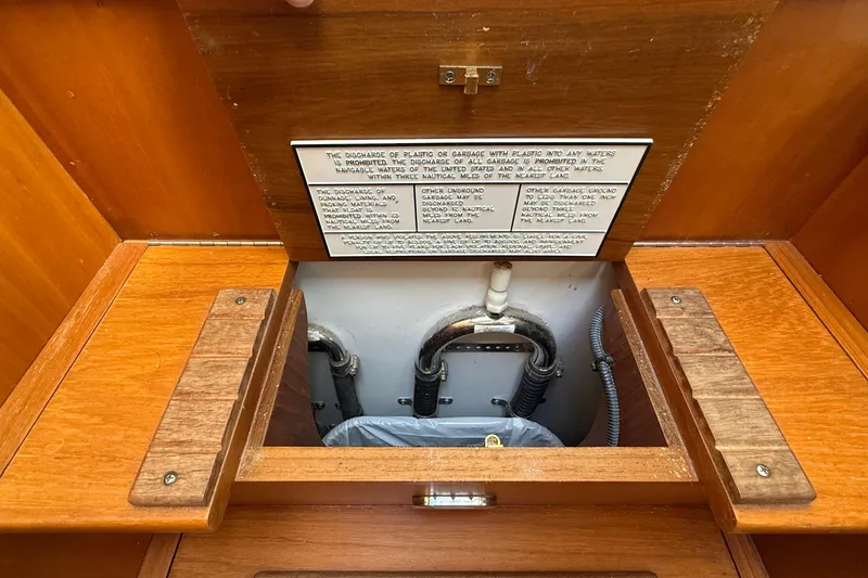 Tova Yacht Photos Pics 2007 Legacy Yachts 32 Sedan interior with open wooden hatch and visible plumbing.