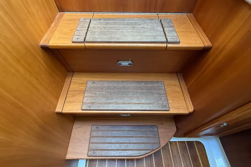 Tova Yacht Photos Pics Wooden steps inside a 2007 Legacy Yachts 32 Sedan, featuring non-slip panels.