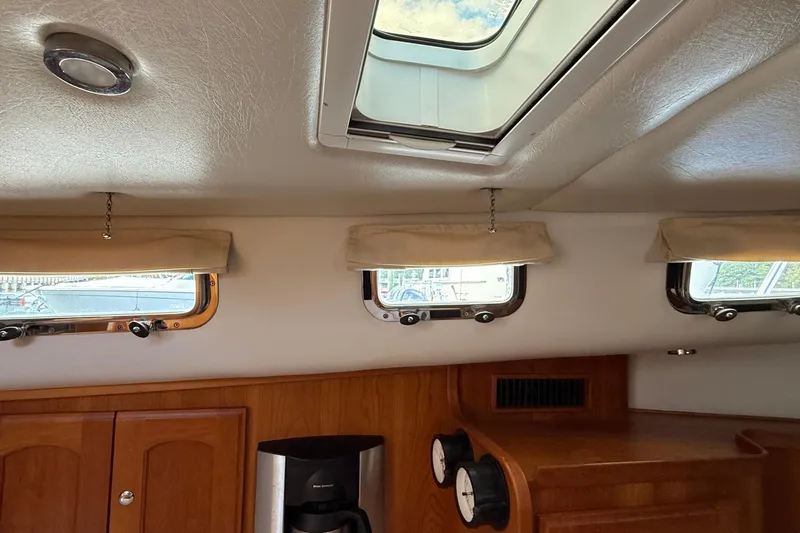 Tova Yacht Photos Pics Interior of 2007 Legacy Yachts 32 Sedan with windows and wooden cabinetry.