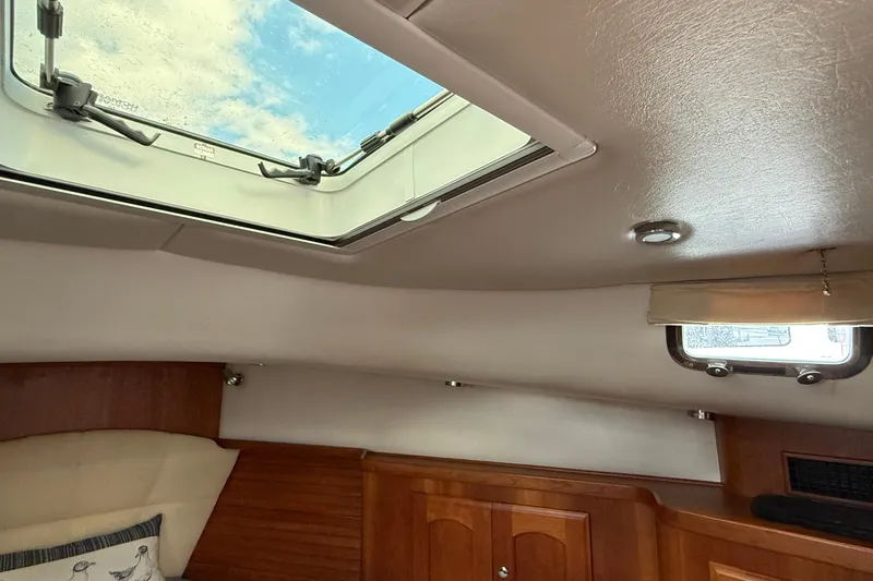 Tova Yacht Photos Pics Interior view of 2007 Legacy Yachts 32 Sedan with skylight and wooden cabinetry.