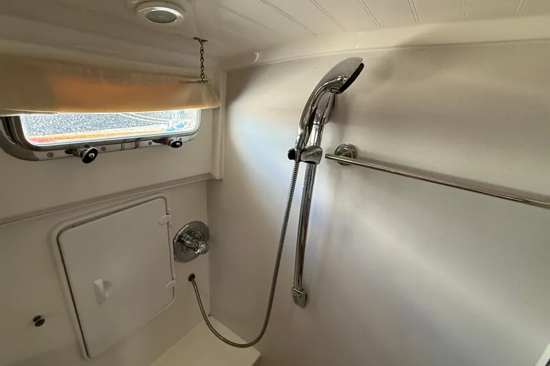 Tova Yacht Photos Pics Shower area in 2007 Legacy Yachts 32 Sedan, featuring chrome fixtures and a window.
