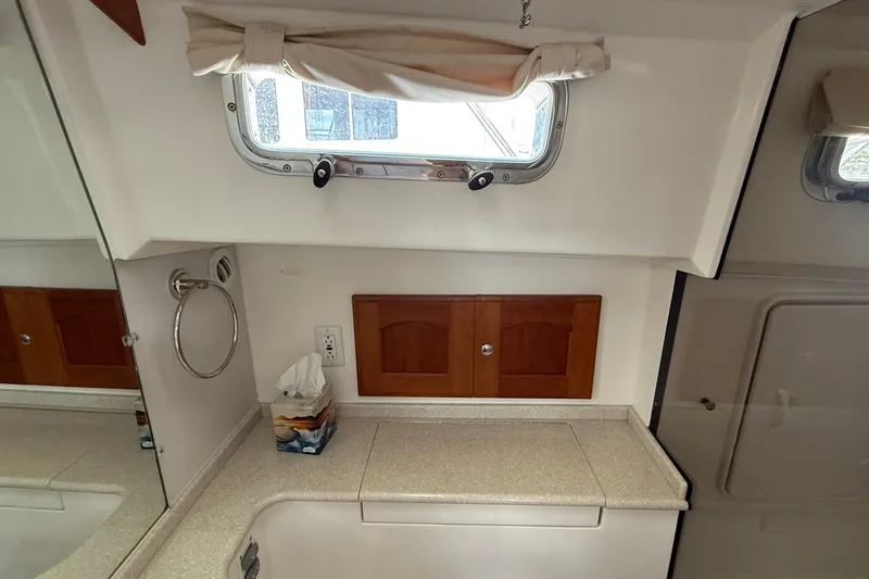 Tova Yacht Photos Pics 2007 Legacy Yachts 32 Sedan interior with countertop, window, and wooden cabinets.