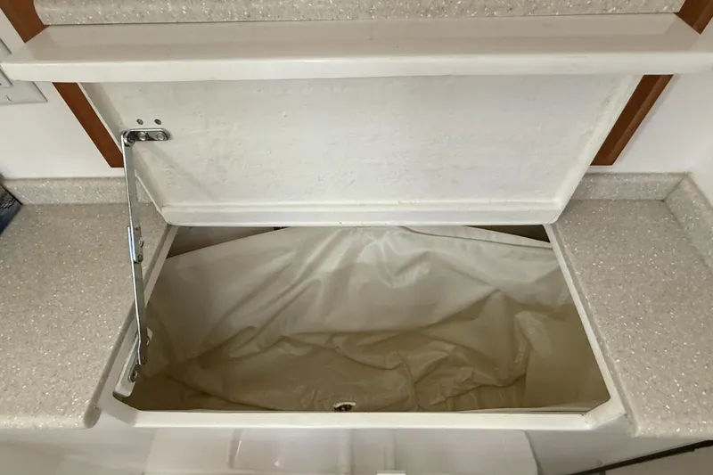 Tova Yacht Photos Pics Open storage compartment on 2007 Legacy Yachts 32 Sedan with beige interior.