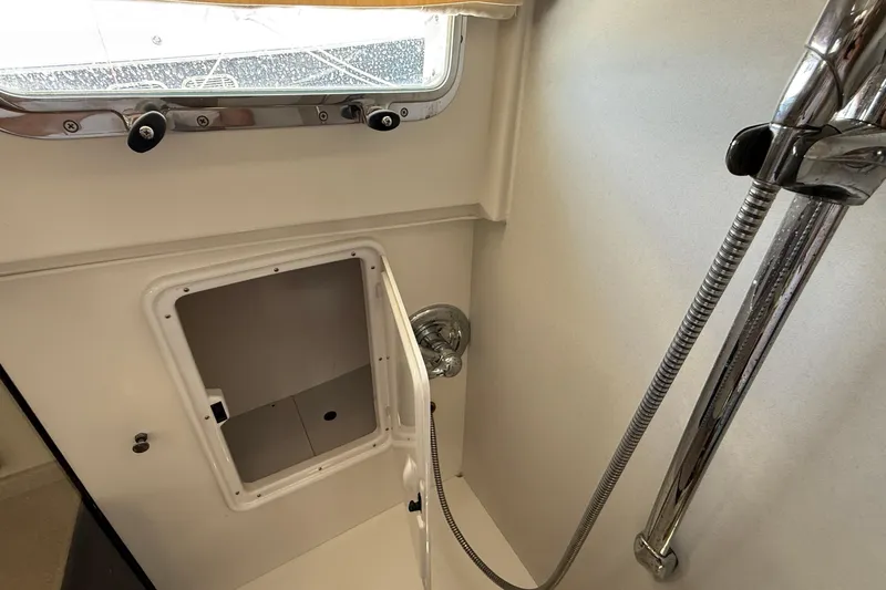 Tova Yacht Photos Pics Shower area in 2007 Legacy Yachts 32 Sedan with storage compartment and window.