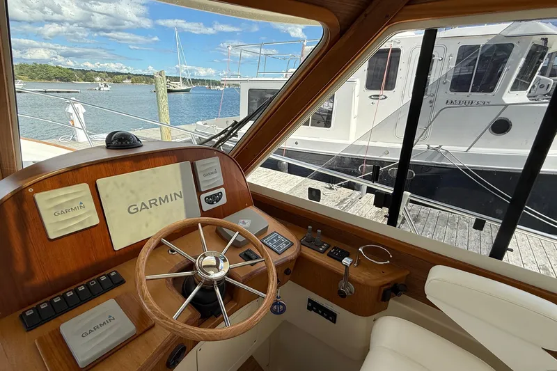 Tova Yacht Photos Pics Interior view of 2007 Legacy Yachts 32 Sedan helm with Garmin navigation system.
