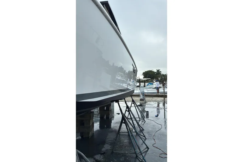 No Name Yacht Photos Pics 2019 Fjord 38 boat on stands, reflecting surroundings in a marina setting.