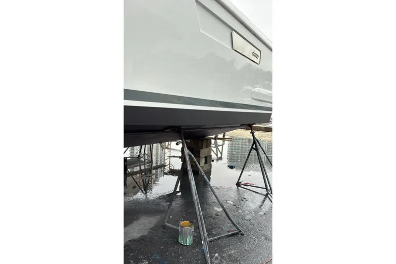 No Name Yacht Photos Pics 2019 Fjord 38 boat on stands for maintenance, with visible hull and paint supplies.