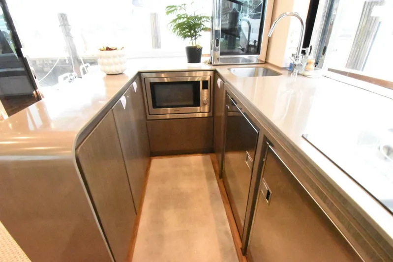 Mojo Yacht Photos Pics Modern kitchen area in 2024 OKEAN 52 yacht with sleek cabinetry and appliances.