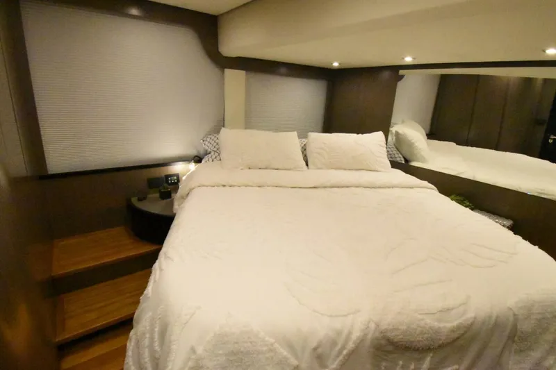 Mojo Yacht Photos Pics Luxurious bedroom interior of 2024 OKEAN 52 yacht with cozy bedding and ambient lighting.