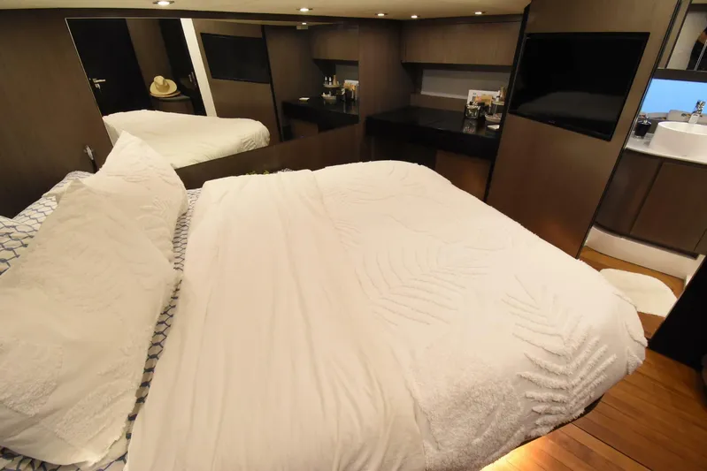 Mojo Yacht Photos Pics Luxurious bedroom interior of 2024 OKEAN 52 yacht with modern design and cozy bedding.