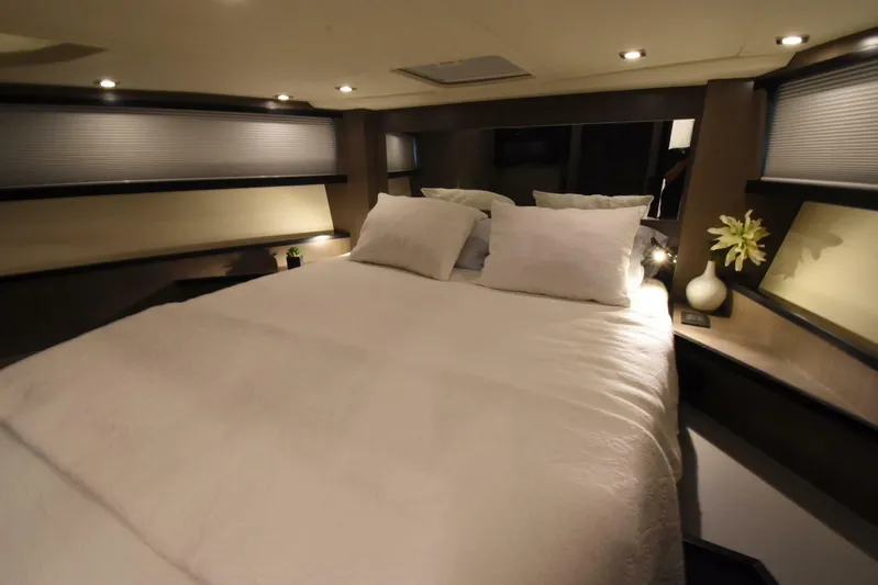 Mojo Yacht Photos Pics Luxurious bedroom interior of 2024 OKEAN 52 yacht with cozy bedding and ambient lighting.