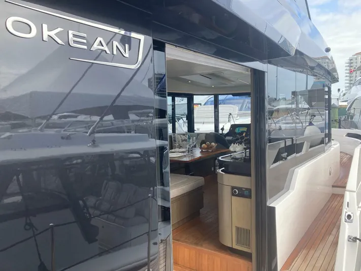 Mojo Yacht Photos Pics 2024 OKEAN 52 yacht with sleek design and luxurious interior at a marina.