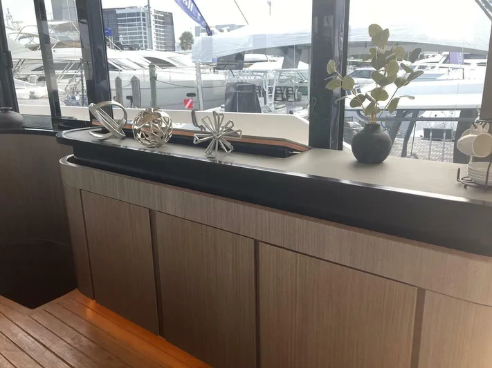 Mojo Yacht Photos Pics Luxurious interior of 2024 OKEAN 52 yacht with modern decor and marina view.