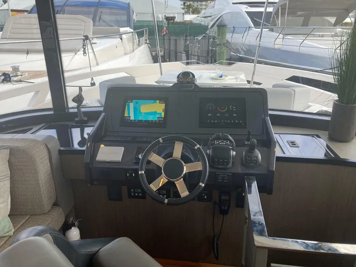 Mojo Yacht Photos Pics 2024 OKEAN 52 yacht helm with modern navigation equipment and steering wheel.