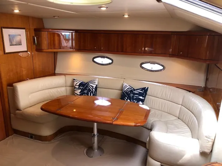 Hotan Yacht Photos Pics Luxurious interior of 2003 Sunseeker Portofino 46 yacht with elegant seating and wooden table.