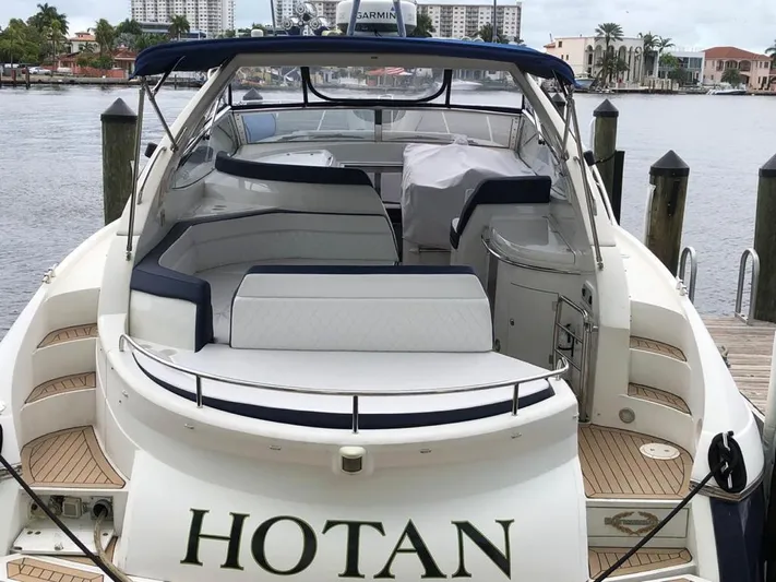 Hotan Yacht Photos Pics 2003 Sunseeker Portofino 46 yacht docked, featuring spacious seating and elegant design.