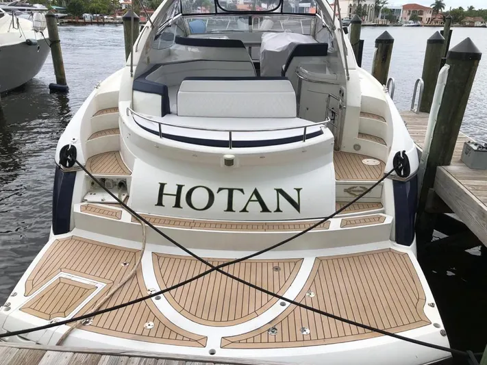 Hotan Yacht Photos Pics 2003 Sunseeker Portofino 46 yacht docked, featuring spacious deck and elegant design.