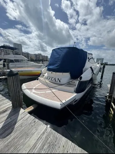 Hotan Yacht Photos Pics 2003 Sunseeker Portofino 46 yacht docked at marina under cloudy sky.