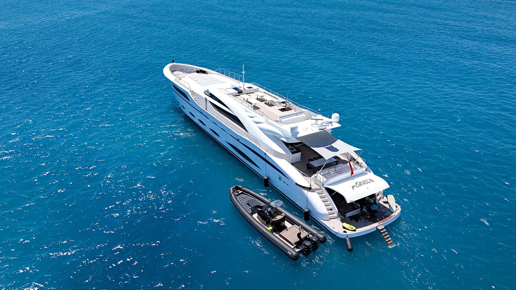 Luxurious 2016 AB Yachts model on clear blue ocean with tender boat.