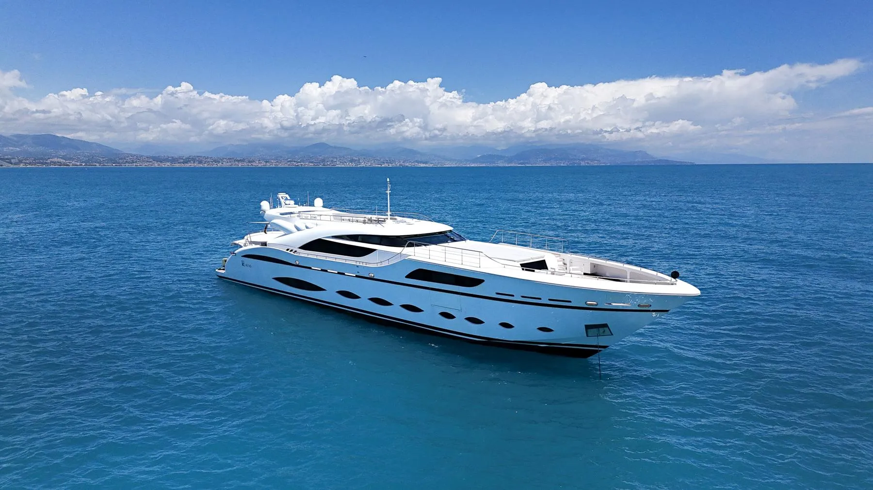 Luxurious 2016 AB Yachts model cruising on serene blue ocean under clear skies.