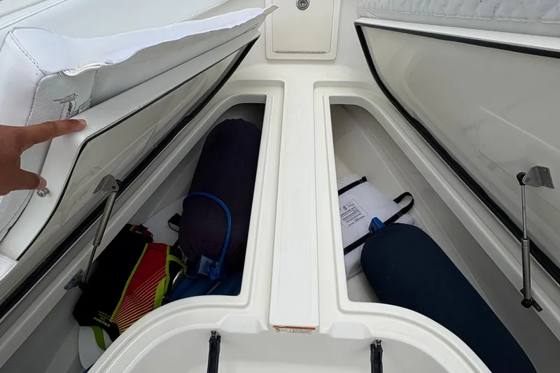 5 O'clock Somewhere Yacht Photos Pics 2007 Hydra-Sports Vector 3300 CC storage compartments with gear and equipment.