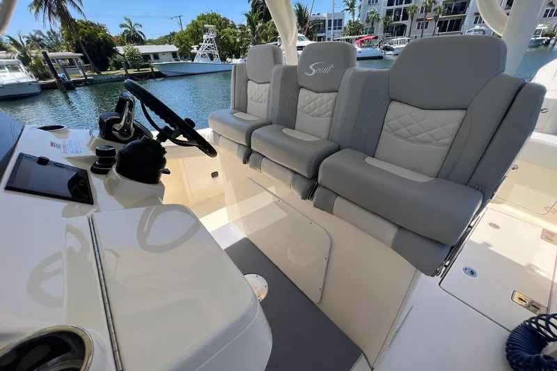  Yacht Photos Pics 2024 Scout 355 LXF boat interior with luxurious seating and steering console.